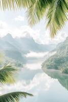 Lush palm fronds frame a serene river landscape with mist rolling over mountains, capturing the peaceful essence of a tropical jungle setting photo