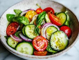 Fresh vegetable salad with basil served in a rustic bowl photo