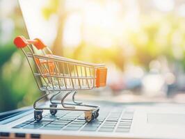 Shopping cart on laptop during sunny day photo