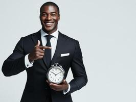 Professional man in suit holding clock while smiling confidently photo