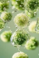 Green spheres float surrounded by water droplets on a pale green background. Macro view of round shapes with textured surfaces and liquid. photo