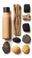 Assorted natural objects are displayed on a solid white surface. Includes a wooden bottle, bark, stones, and small black seeds, creating a natural composition. photo