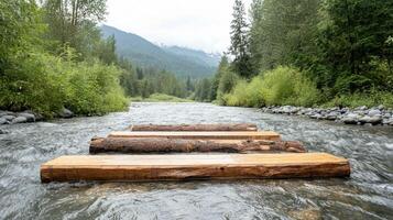 Logs crossing flowing river in forest. Water flows around wood. Trees and mountains in background. Natural landscape with water and vegetation. photo
