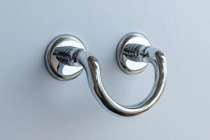 Shiny chrome drawer pull handle reflecting on a white background photo