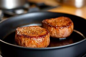 Chef cooking delicious beef fillets in frying pan photo