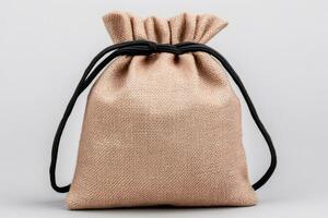 Small hessian sack with black string standing on white background photo