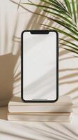 Smartphone Standing on Books with Tropical Shadows photo