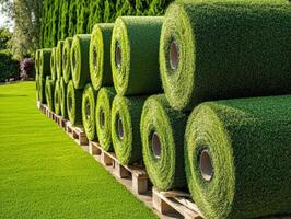 Rolls of artificial grass ready for installation in a sunny location photo