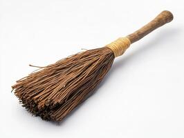 Craft tool with a wooden handle and intertwined straw bristles photo