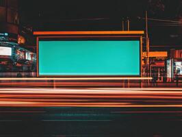Urban night scene with a digital billboard and light trails photo