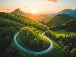 Winding road through lush mountains at sunset in a serene landscape photo