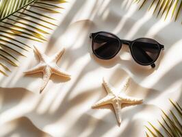 Sunglasses and starfish decorate sandy beach setting photo