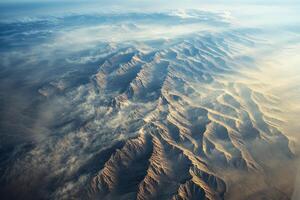 Mountain ranges covered by mist during golden hour light photo