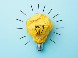 Bright idea represented by crumpled paper light bulb concept photo
