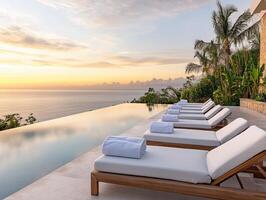 Luxurious poolside view overlooking the ocean at sunset photo