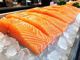Fresh salmon fillets displayed on ice at a seafood market photo