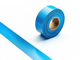 Roll of blue tape on a plain white background for various uses photo