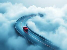 Red car navigating a winding road through a foggy landscape photo