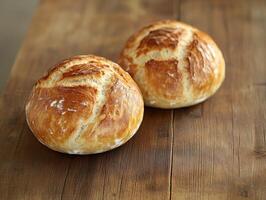 Freshly baked bread rolls on a wooden table photo