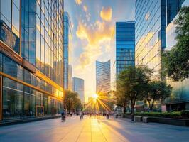 Vibrant sunset in a modern urban setting with people walking along photo
