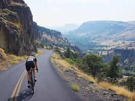 Cyclist navigating scenic mountain road in summer daylight photo