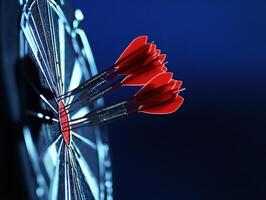 Darts hitting the bullseye on a dark blue dartboard photo
