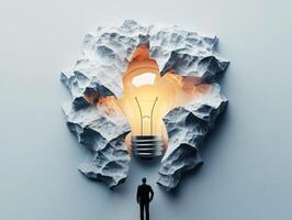 Innovative concept of breakthrough idea with a glowing light bulb photo