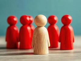 Wooden figure stands out among red figures in a creative setting photo