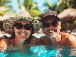 Smiling couple enjoying a sunny day by the pool photo