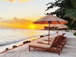 Relaxing beachside loungers at sunset by the calm ocean waves photo