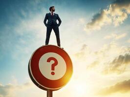 Businessman stands atop question mark sign at sunset, contemplating decisions during golden hour in urban setting photo
