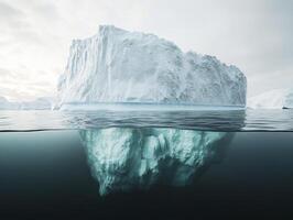 Majestic iceberg floating in calm arctic waters during a cloudy day in late afternoon light photo