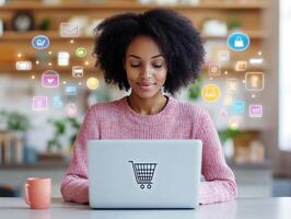 Young woman engaged in online shopping while using a laptop at home with colorful icons representing e-commerce photo