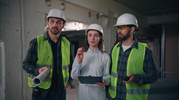 Professional Caucasian colleagues team discussing building in construction guys technicians contractors speaking builders communicate walkie talkie woman controller control production inspector plan video