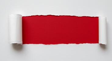 A red piece of paper is rolled up and placed on a white surface photo