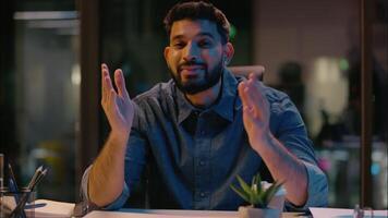 Web camera view Indian ethnic man smiling businessman business coach entrepreneur HR manager employer mentor influencer speaker talking consultation online teaching consult commerce in night office video