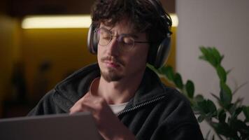 Thoughtful Hispanic guy thinking typing keyboard laptop at home programmer man working remote business freelancer searching information website cyberspace broker male looking gadget pc contemplating video