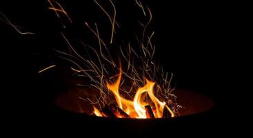 A fire pit with flames and smoke coming out of it photo
