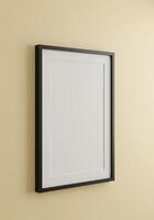 A blank picture frame on a wall photo