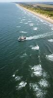 A boat is traveling in the ocean photo