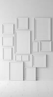 Empty white frames on a wall in an empty room photo