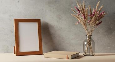 Blank frame mockup on a table with a book and a vase of dried grasses photo