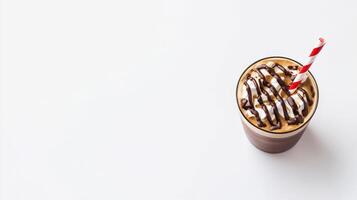 A delicious iced coffee drink features a creamy texture topped with hmallows and chocolate drizzle served in a clear glass with a red and white striped straw on a white photo