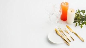 A table setting with gold cutlery and candles photo