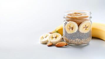 A delicious and healthy chia seed pudding parfait layered with banana slices and peanut butter in a glass jar is perfect for a nutritious breakfast or snack. photo