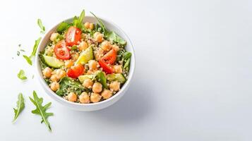A vibrant and healthy quinoa salad bowl brimming with chickpeas, avocado, cherry tomatoes, and arugula for a delicious and nutritious meal option. photo