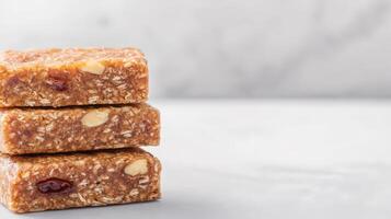 Three delicious homemade granola bars stacked on a light marble surface create a tempting and healthy snack image perfect for food blogs and websites. photo