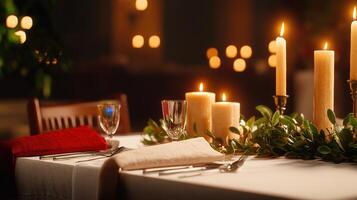 A romantic candlelit dinner table setting is elegantly prepared with linen tablecloth, silverware, glasses, and greenery creating a warm and inviting ambiance for a special photo
