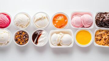 A delicious assortment of ice cream scoops and toppings in small white cups arranged in a neat row on a bright white background perfect for summer food blogs or menus. photo