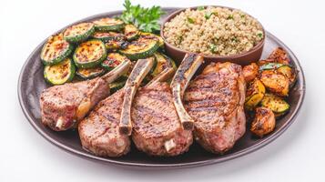 Delicious grilled lamb chops served with seasoned zucchini, roasted potatoes, and a side of fluffy quinoa creating a healthy and visually appealing gourmet meal. photo
